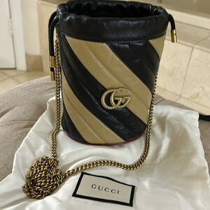 Gucci GG Marmont Bucket Bag in Black & Beige & red trim.  Excellent condition.